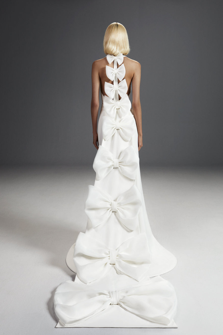 Viktor & Rolf Mariage Bridalwear Collection 'Dreamy Bow Mermaid' gown with cascading bows, elegant couture design.