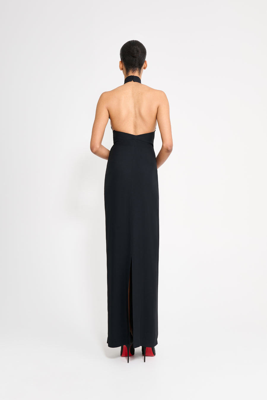 Woman wearing a black halter neck gown on a white background