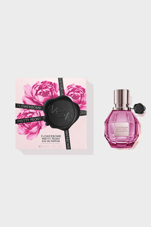 Pretty Peony Flowerbomb perfume in a pink bottle with a box next to it on a white background.