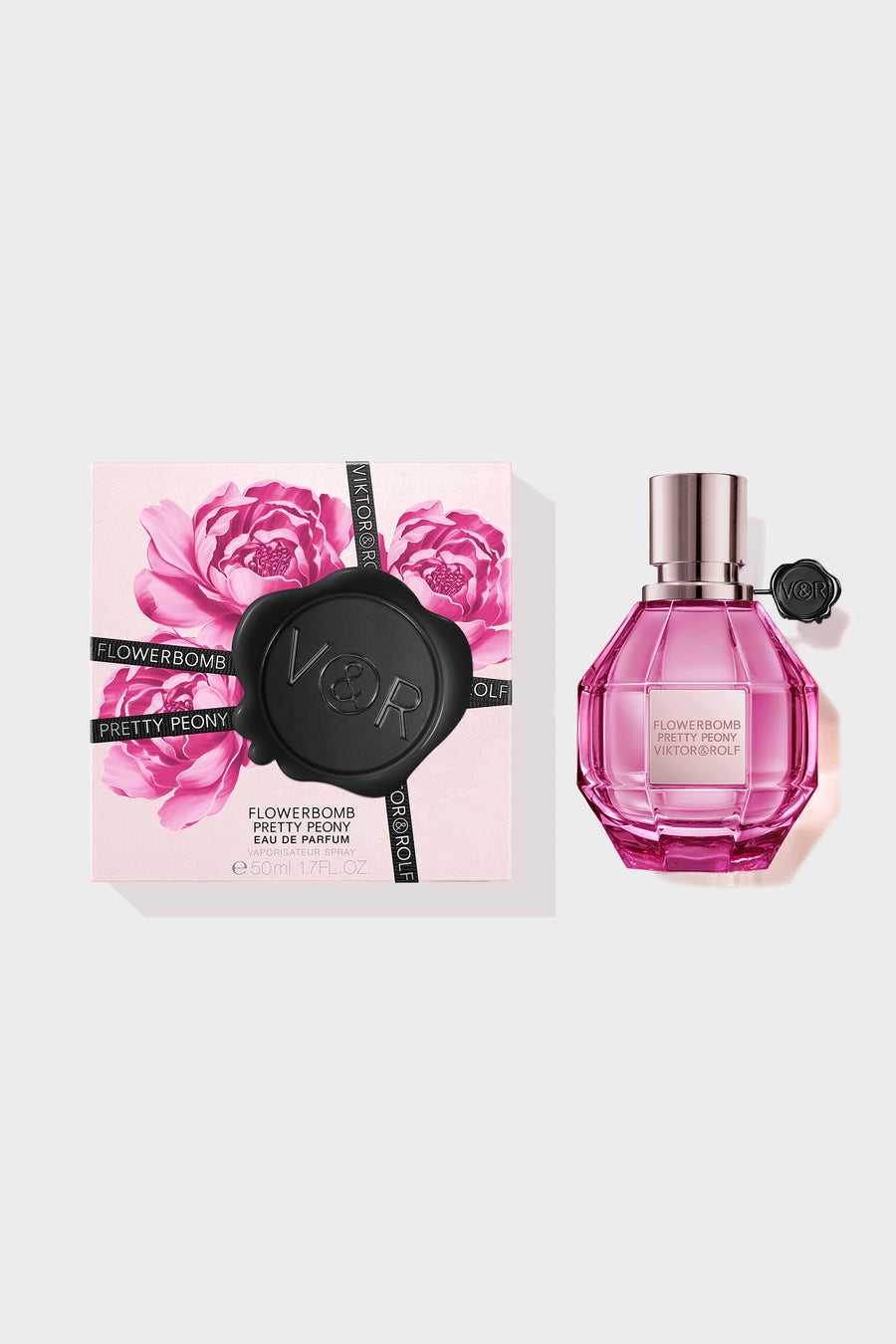 Pretty Peony Flowerbomb perfume in a pink bottle with a box next to it on a white background.