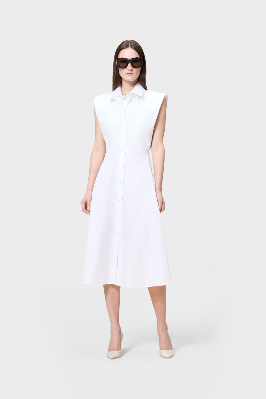 Woman wearing a white sleeveless dress on a white background