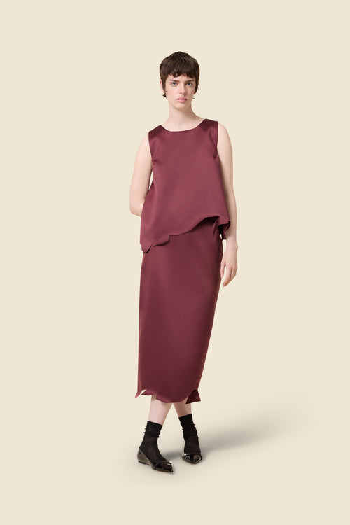 Sleek burgundy sleeveless dress with asymmetrical hem, elegantly crafted in satin fabric, showcasing minimalist chic style.