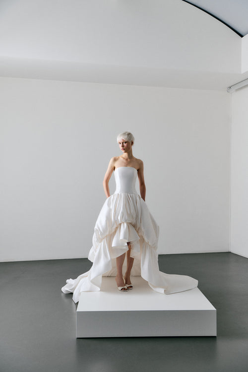 White wedding dress on a mannequin in a minimalistic setting