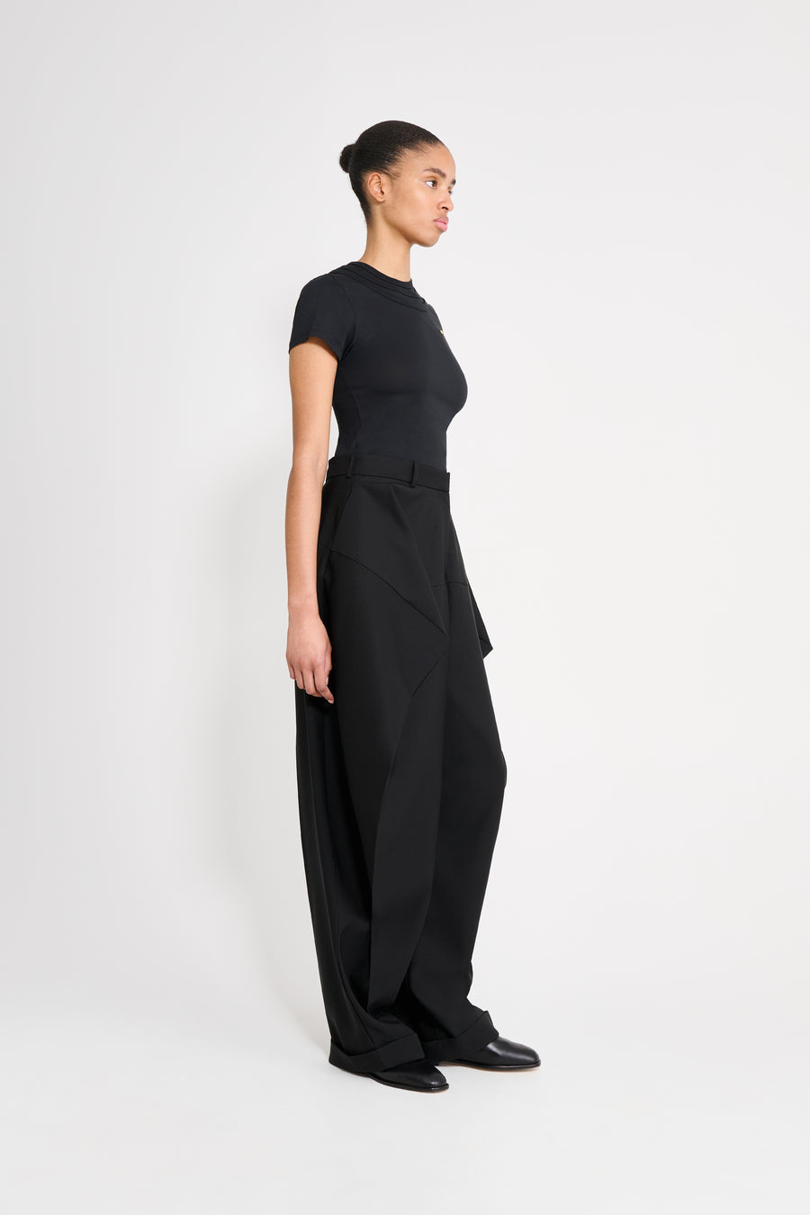 Person wearing a black outfit on a white background