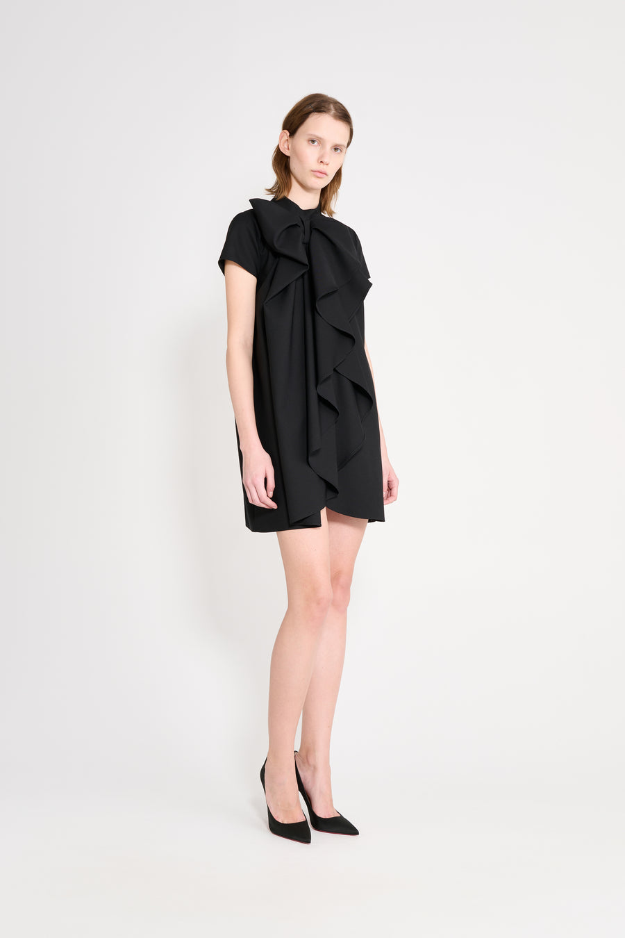 Model wearing a black dress.