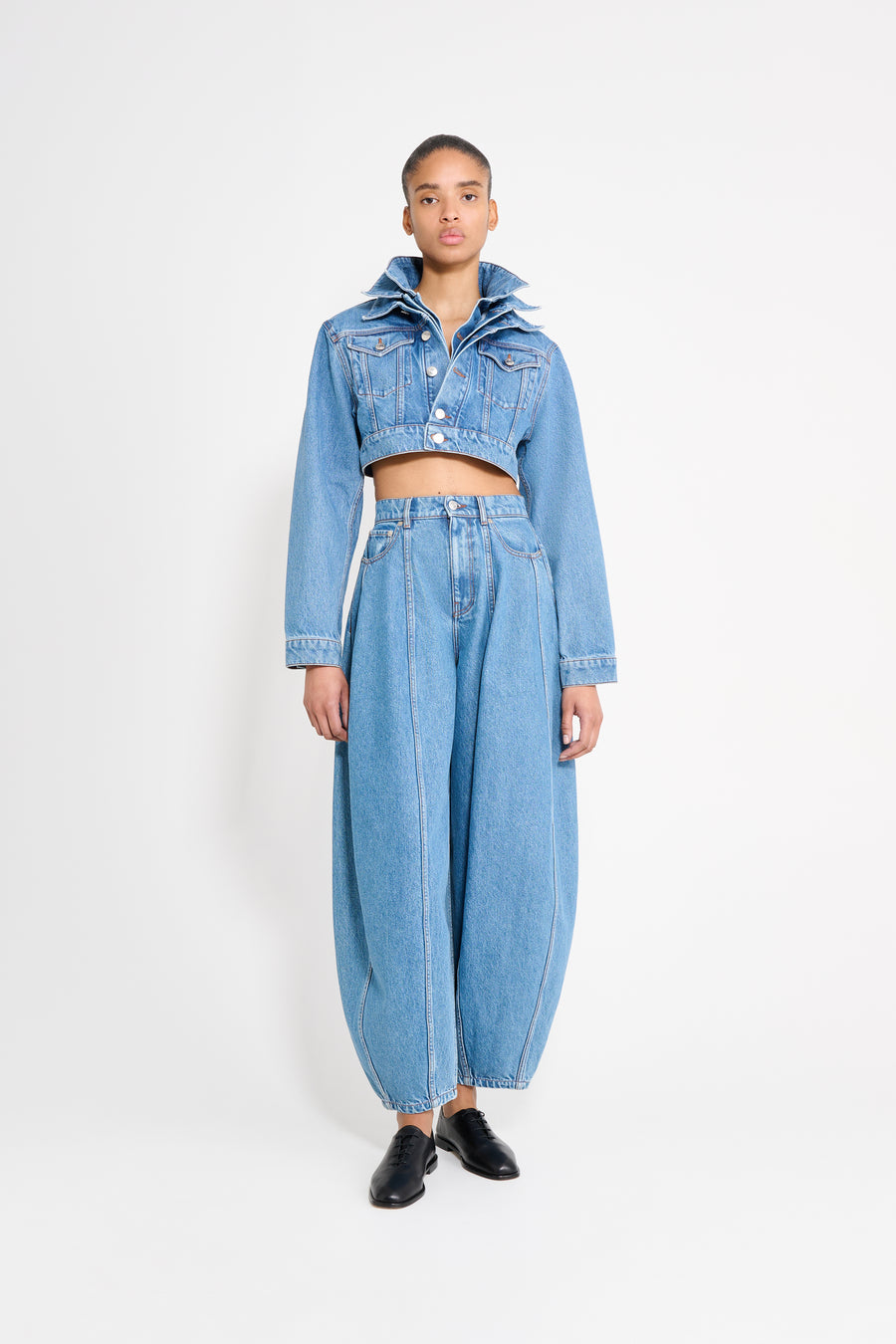 Person wearing a denim outfit on a white background