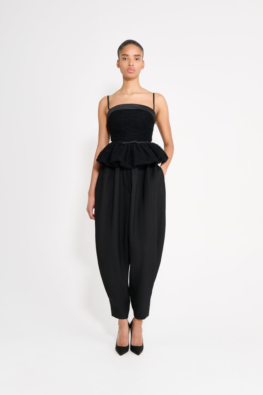 Model wearing a black top.