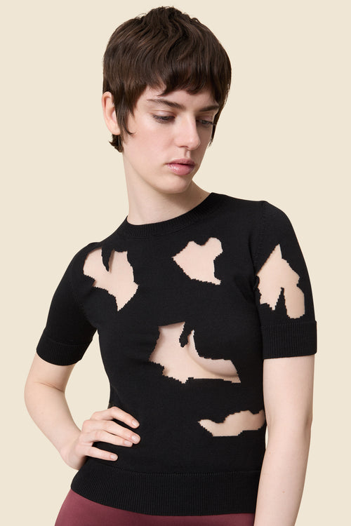 Sleek black satin dress featuring a bold geometric neckline and a fitted waist, highlighting a sophisticated style.