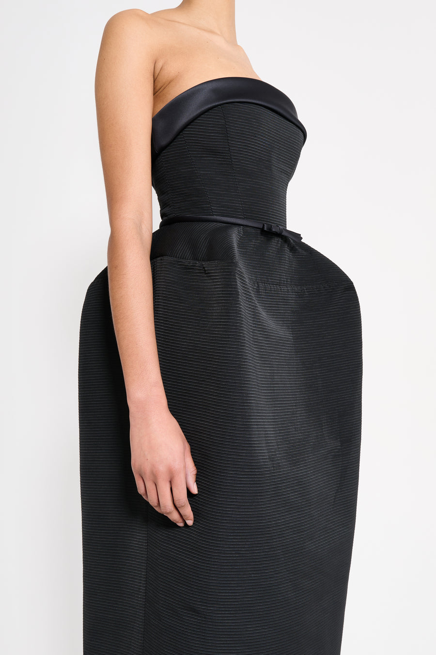 Black strapless gown on a white background