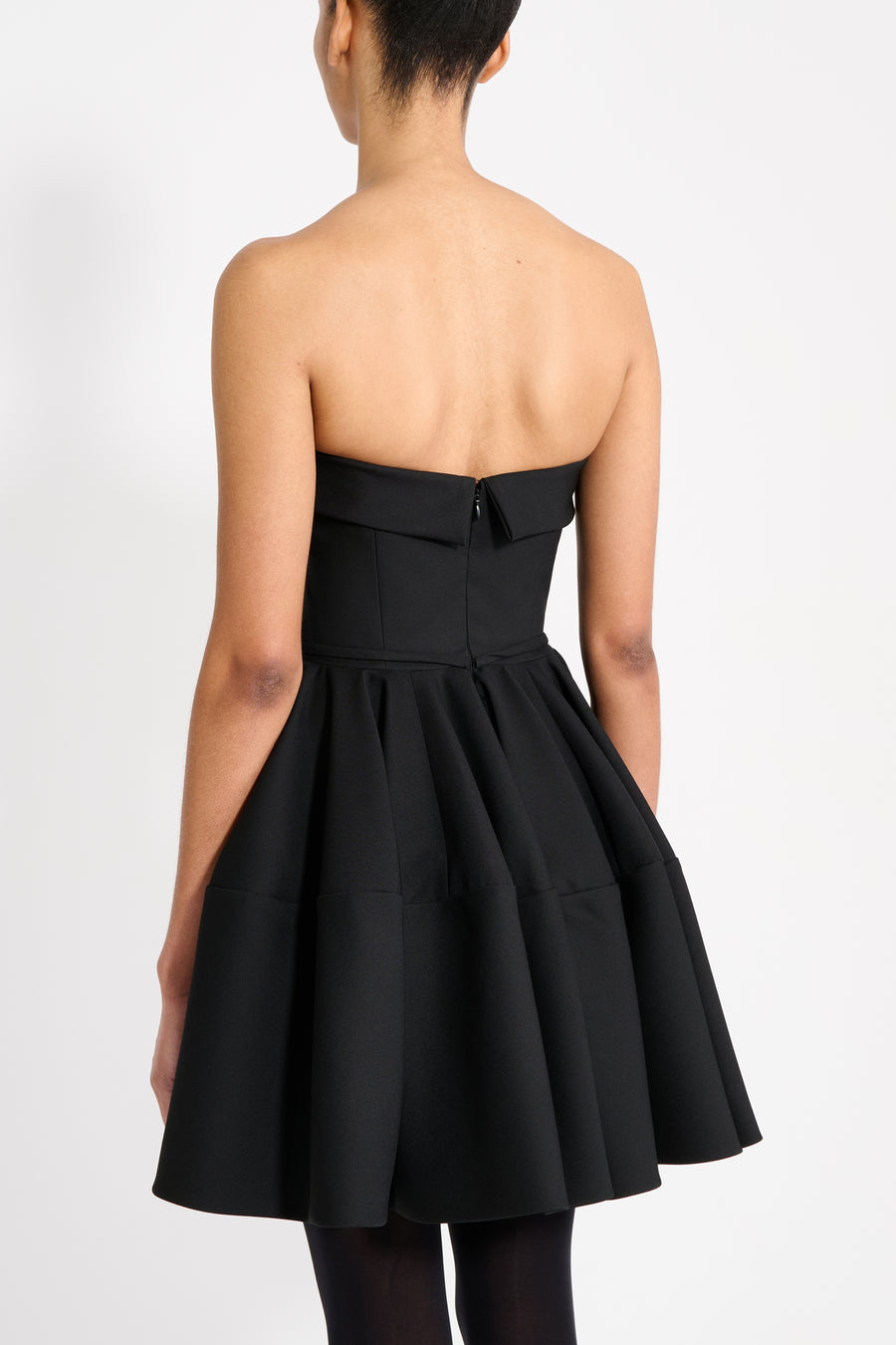 Black strapless dress with a bow detail on a white background