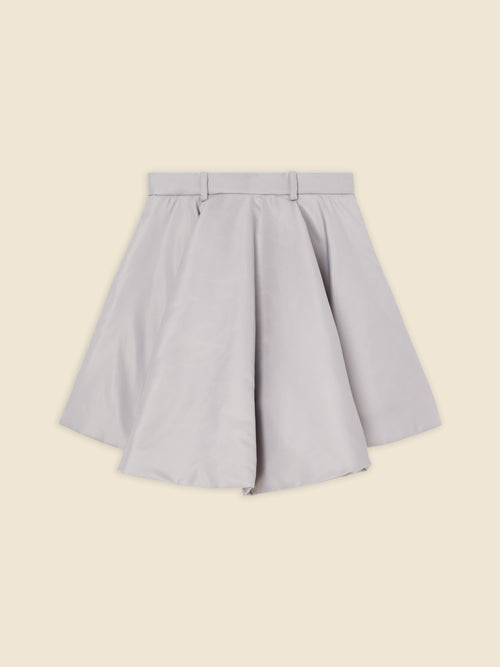 High-waisted A-line skirt in soft gray fabric with structured pleats and belt loops, creating a chic and versatile look.