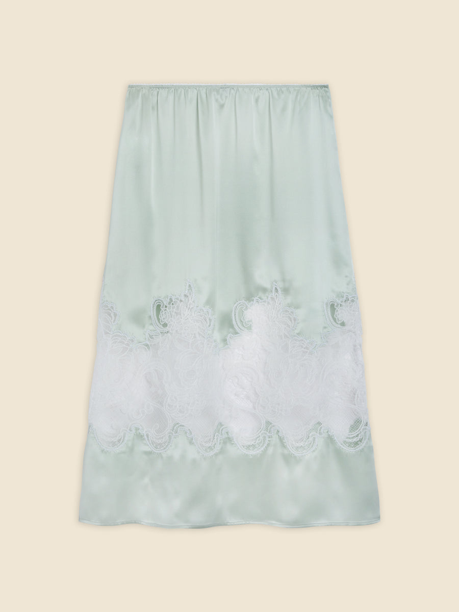 Mint green satin skirt with intricate white lace detailing at the hem, providing an elegant and sophisticated look.
