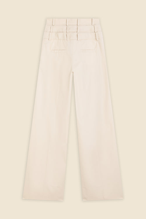 Beige multi-layer high waist trousers on a beige background.