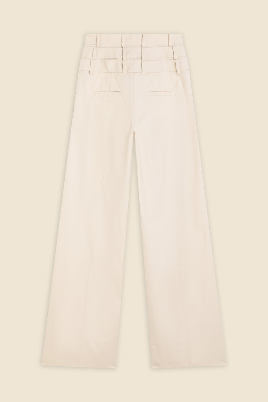 Beige multi-layer high waist trousers on a beige background.