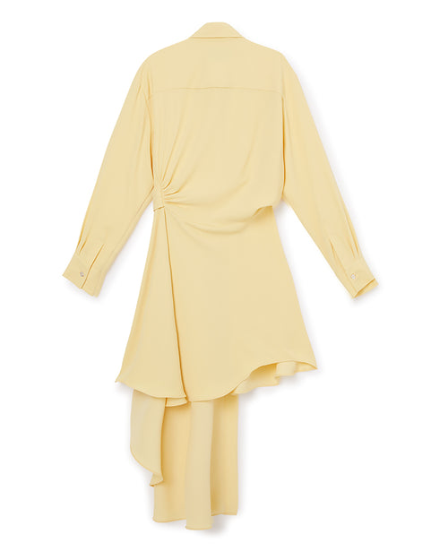 Light yellow asymmetrical shirt dress with long sleeves and a draped back detail, showcasing elegant minimalist design.