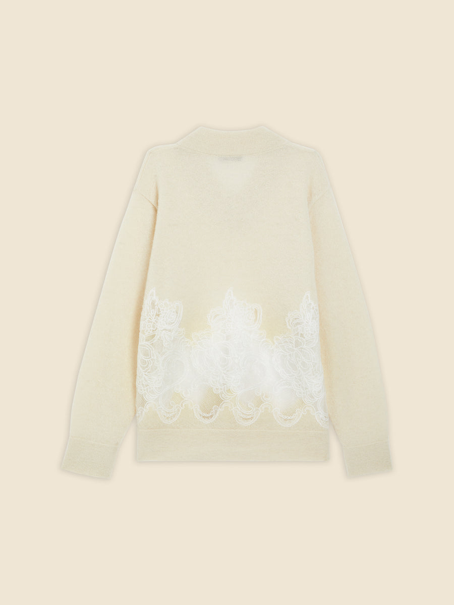Cream sweater featuring intricate white lace embroidery along the back, adding elegance to the soft woolen texture.
