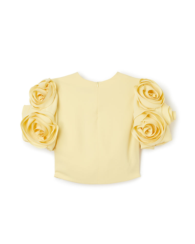 Exquisite yellow blouse with oversized rosette sleeves, crafted to add elegance and flair to any fashion ensemble.