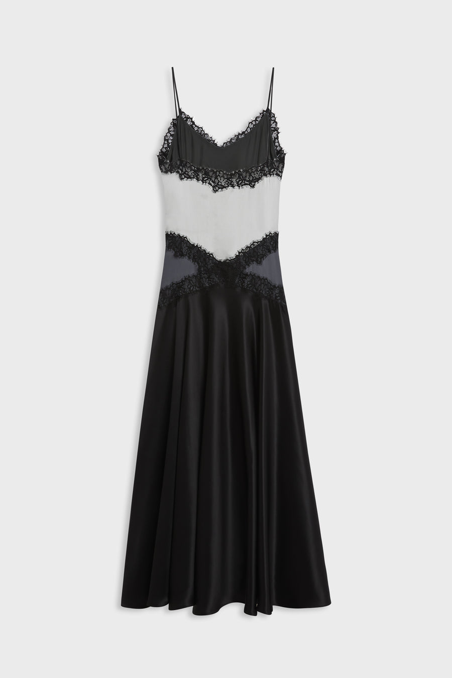 A black and white color-blocked midi slip dress with black lace trim and thin spaghetti straps, shown against a light gray background.