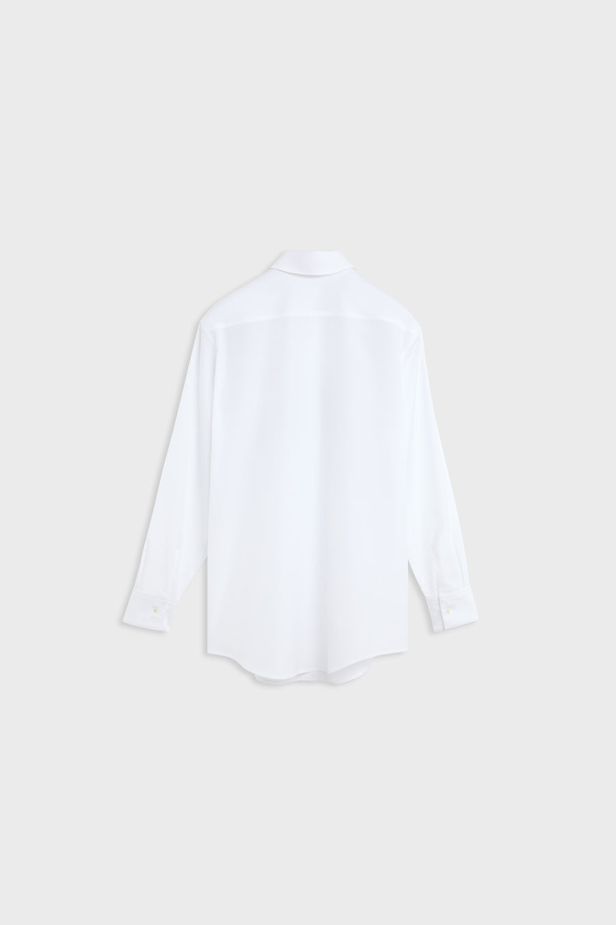 A white long-sleeve button-up shirt shown from the back, photographed flat against a light gray background.