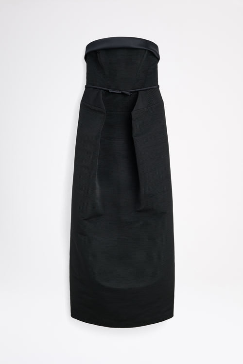 Black dress with a bow detail on a white background