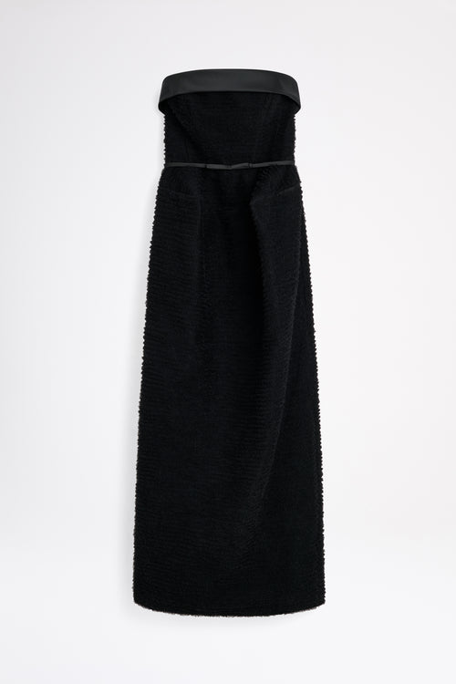 Black strapless dress with a fitted bodice on a white background