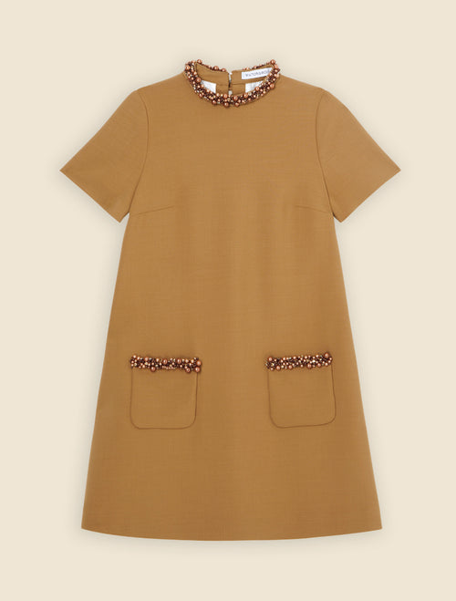 Elegant mustard wool dress featuring pearl embellishments on the neckline and pocket edges, with short sleeves.