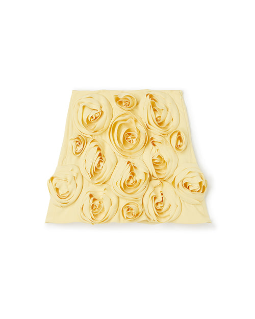 Elegant yellow skirt adorned with intricate rosette fabric detailing, showcasing a sophisticated floral design aesthetic.