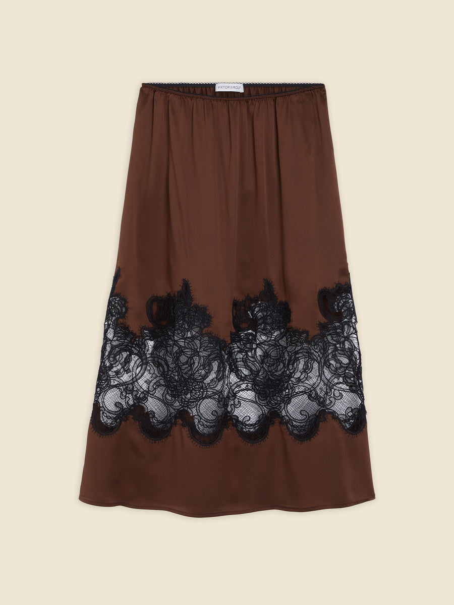 Elegant brown silk slip skirt with intricate black lace detailing, creating a sophisticated and luxurious look.
