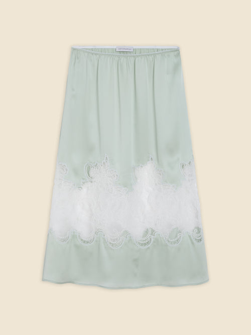 Mint green satin skirt featuring intricate white lace embroidery at the hem, creating a delicate and elegant look.