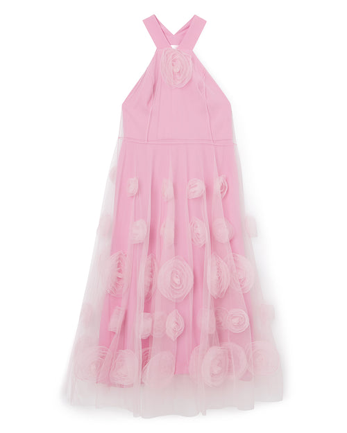 Pink tulle dress with rose appliqués, features a cross strap neckline, and layered skirt, creating a delicate, floral look.