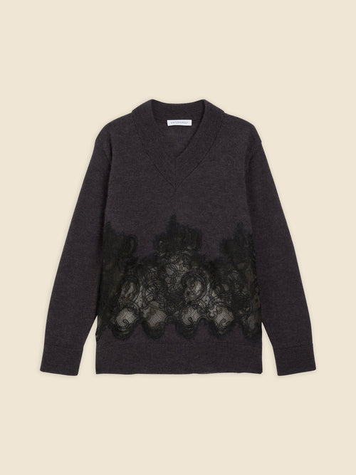 Dark gray sweater with intricate black lace detailing across the front, featuring a deep V-neck and long sleeves.