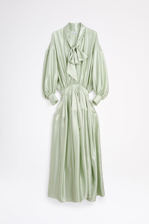 Light green dress with a bow detail on a white background