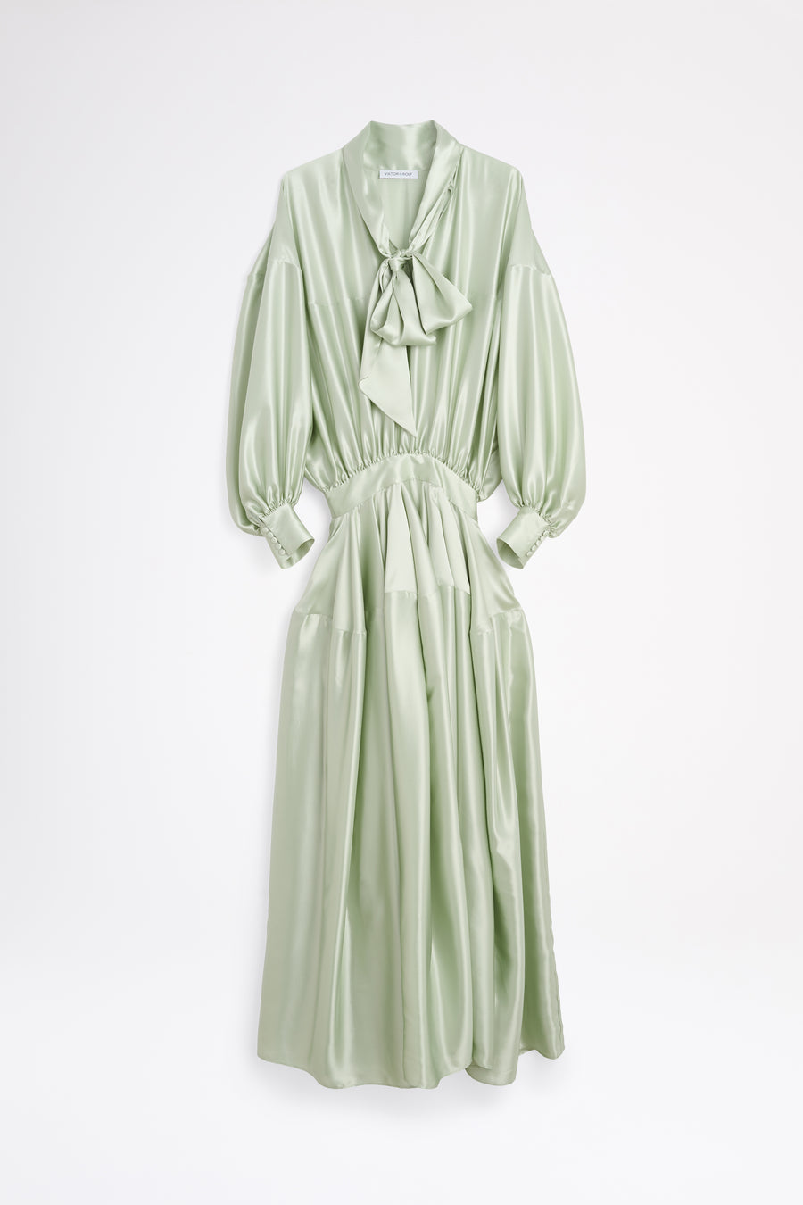 Light green dress with a bow detail on a white background