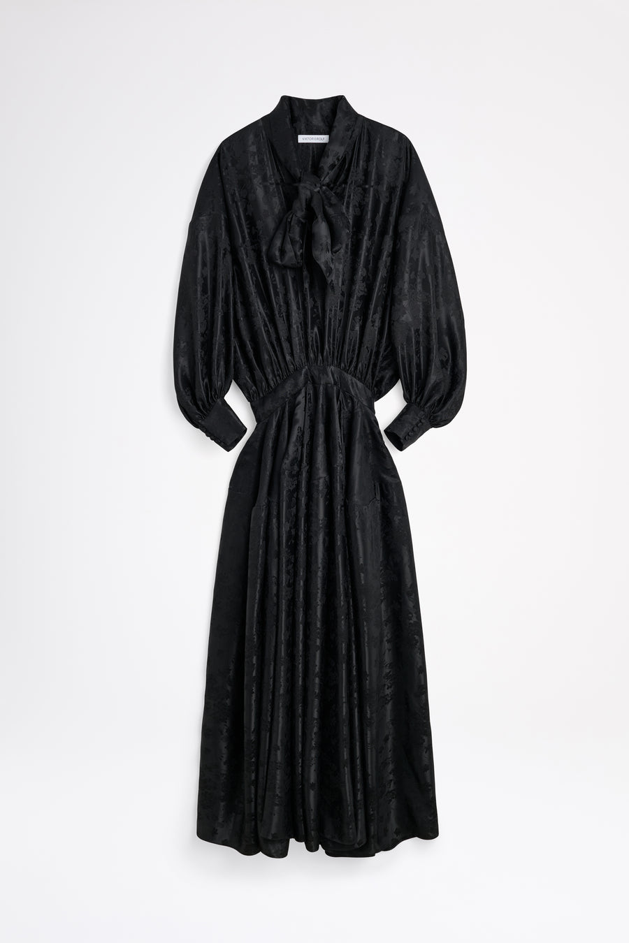 Black dress with a tie neckline on a white background