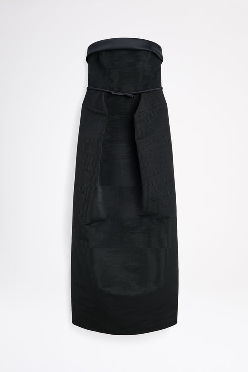 Black dress with a bow detail on a white background
