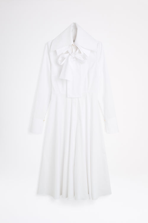 White halter neck dress on a light gray background