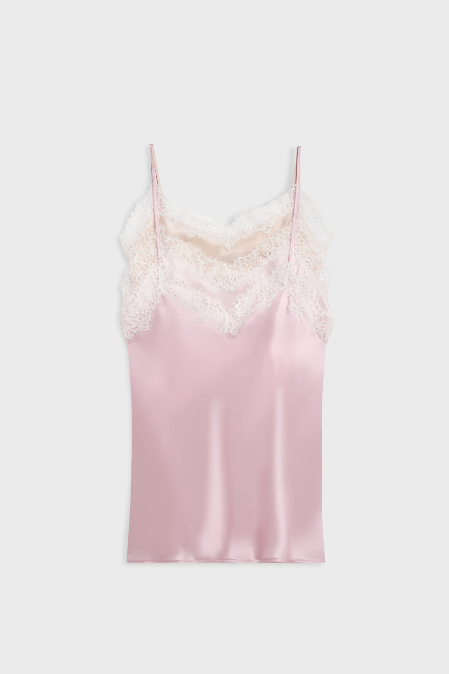 A light pink satin camisole slip with white lace trim along the neckline and thin spaghetti straps, shown flat against a light gray background.