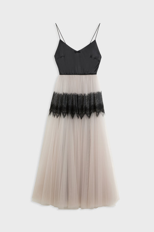 A sleeveless spaghetti-strap dress with a black bodice and a layered tulle skirt in pale blush and black lace, shown against a light gray background.