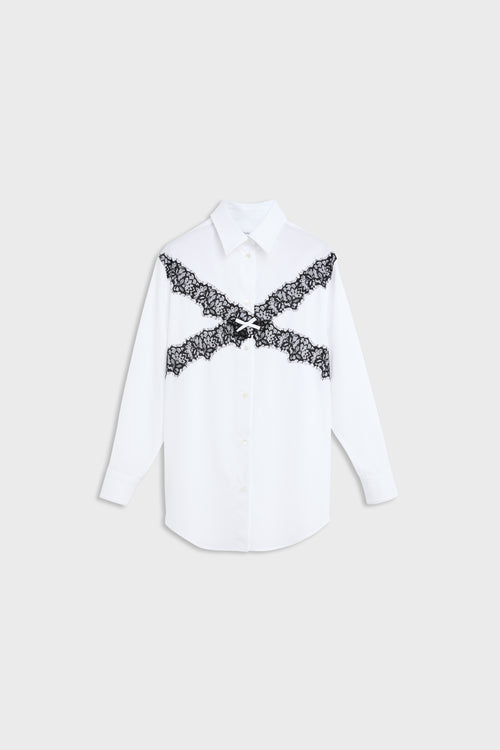 A white long-sleeve button-up shirt with a black lace X-shaped graphic across the chest, displayed flat against a light gray background.
