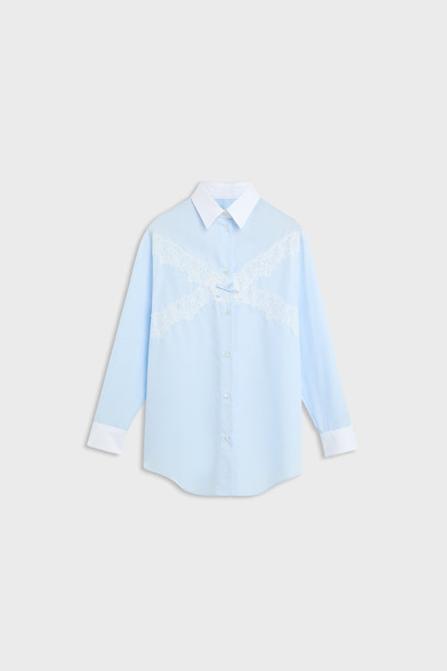 A light blue long-sleeve button-up shirt with a white collar, white cuffs, and white embroidered lettering across the chest, displayed on a light gray background.