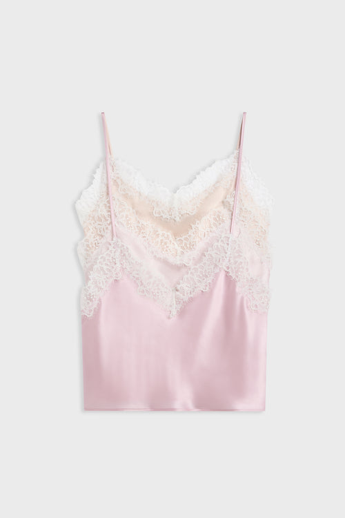 A light pink satin camisole top with white lace trim along the neckline and thin spaghetti straps, displayed flat against a light gray background.