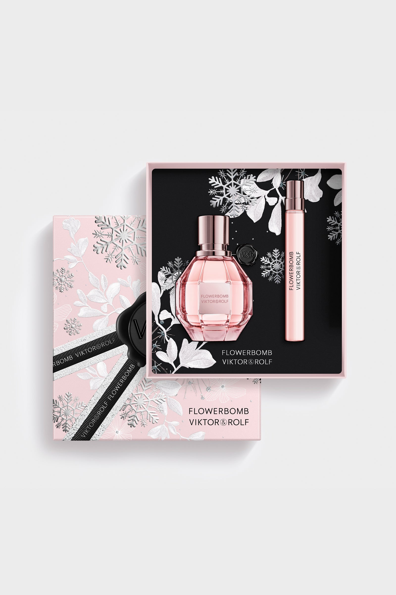 Elegant pink Flowerbomb gift set by Viktor & Rolf, featuring a faceted perfume bottle and sleek, floral-themed packaging for women.