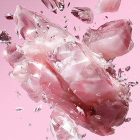 Image of a pink crystal breaking, on a pink background.