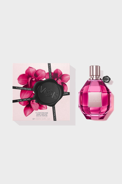 Pink Flowerbomb perfume on a white background with a box next to it.