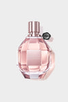 A feminine, diamond-cut glass bottle of Flowerbomb by Viktor & Rolf, featuring a blush pink fragrance for women with floral notes.