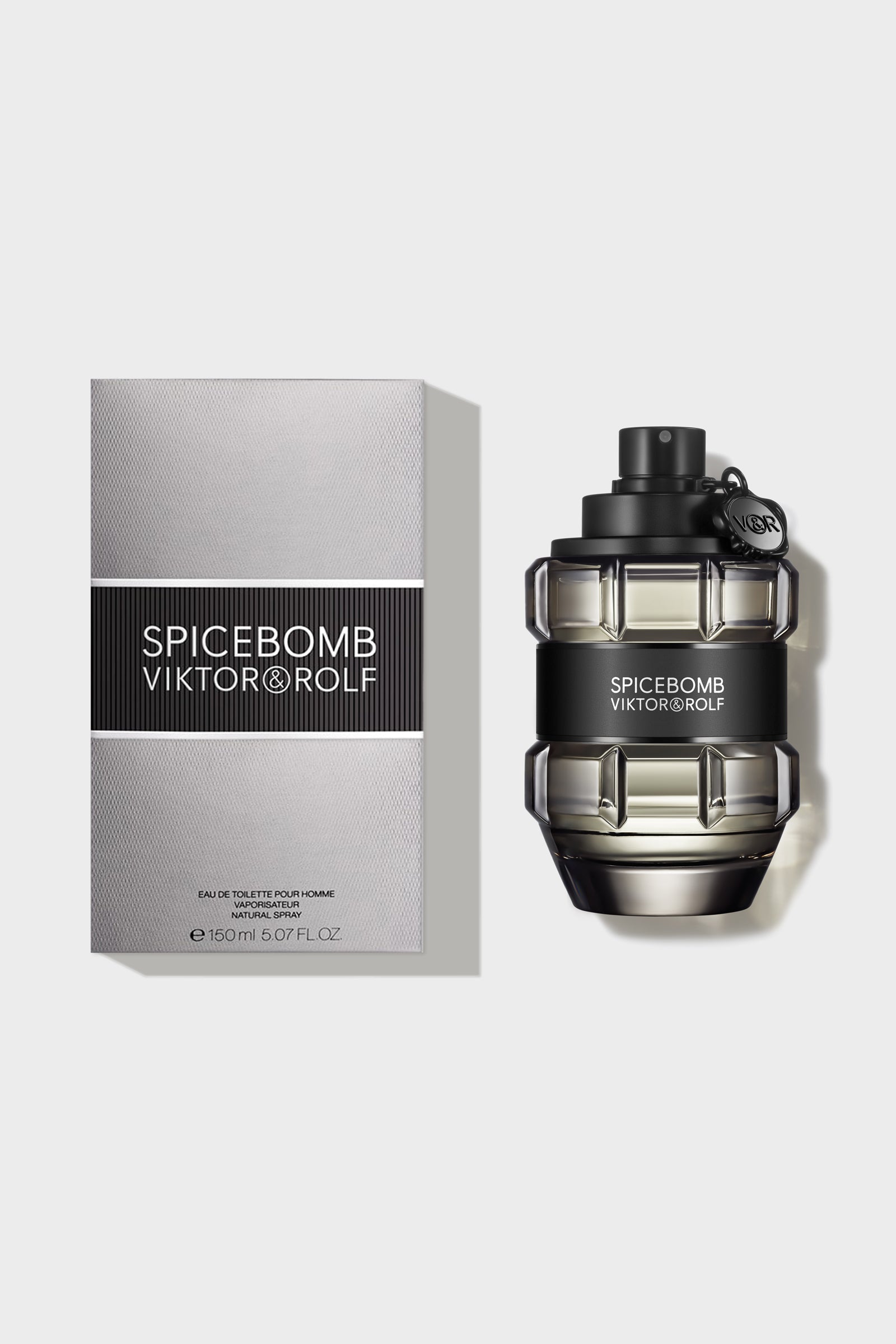 Elegant grenade-shaped bottle of Viktor & Rolf Spicebomb fragrance with a sleek black cap and label on a beige backdrop.