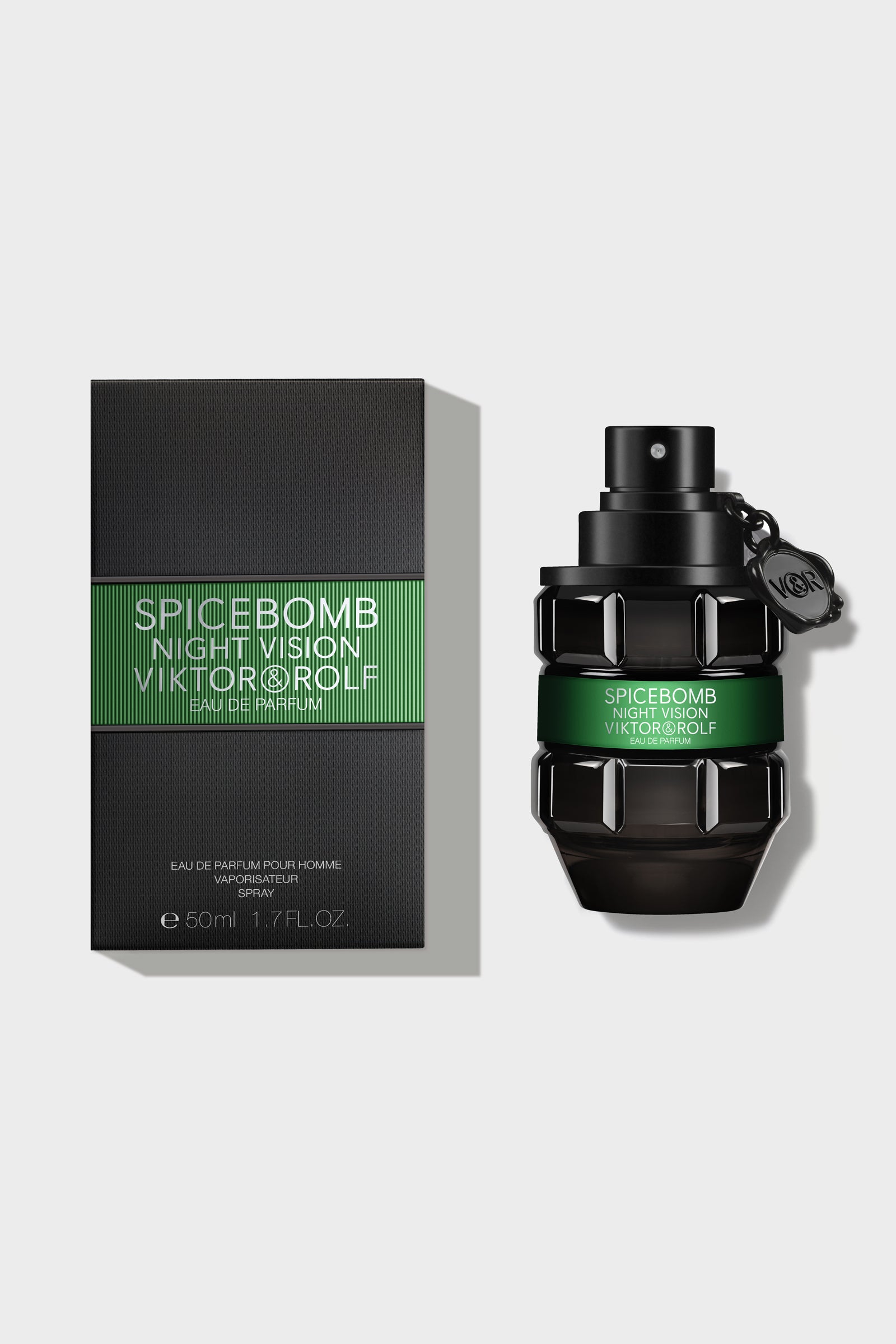 Luxurious black and green glass perfume bottle with intricate geometric design, elegantly labeled 
