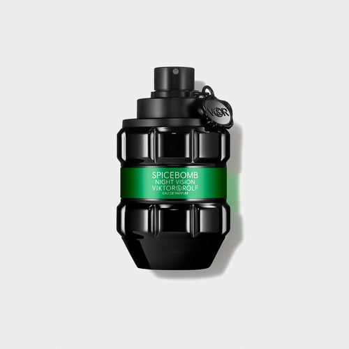Luxurious black and green glass perfume bottle with intricate geometric design, elegantly labeled "Night Vision Eau de Parfum."
