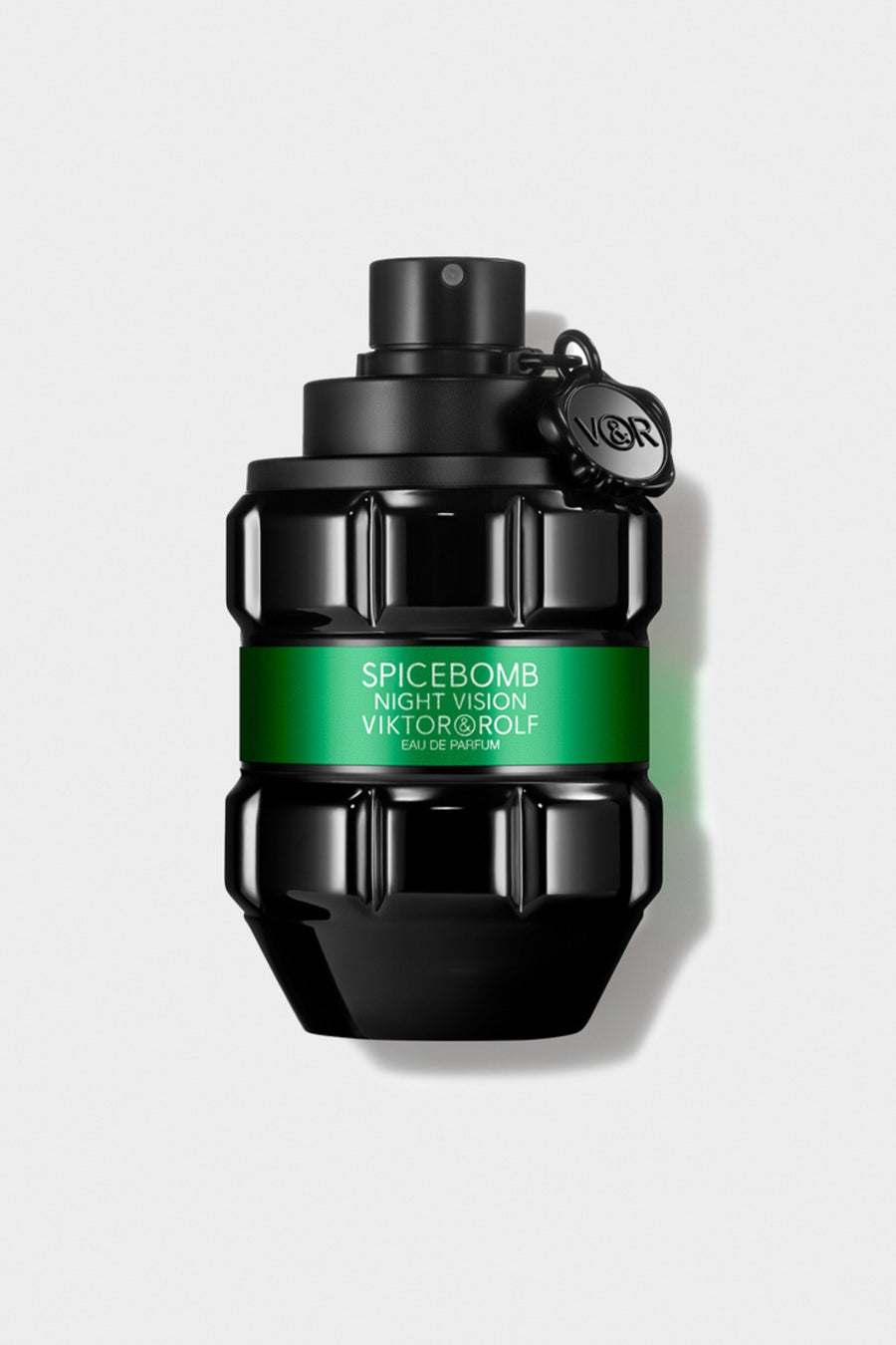 Luxurious black and green glass perfume bottle with intricate geometric design, elegantly labeled "Night Vision Eau de Parfum."