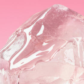 Close-up of pink and white glossy texture on a pink background